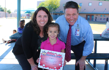  a student holds a certificate with principal jennifer griggs and WESD superintendent Stanton